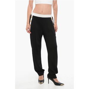 Gebreide broek met decoratieve knopen in zwart-wit