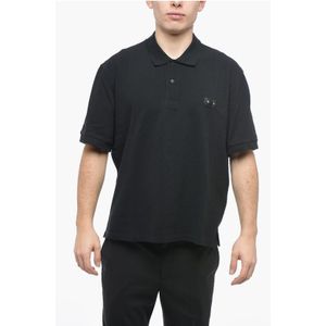 Piqué katoenen polo met doorboorde tepels en losse pasvorm in zwart