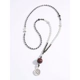 Ketting Medea van geslepen glaskralen en jade Juwelenkind zwart