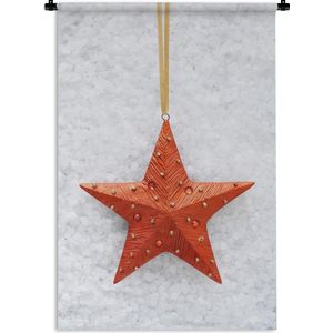 Wandkleed Kerst - Een rode ster met een besneeuwde achtergrond Wandkleed katoen 60x90 cm - Wandtapijt met foto