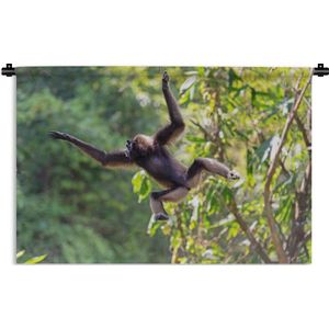 Wandkleed Junglebewoners - Springende aap in de jungle Wandkleed katoen 90x60 cm - Wandtapijt met foto