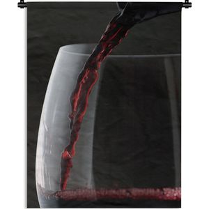 Wandkleed Rode wijn - Prachtige close up van een glas rode wijn dat wordt ingeschonken Wandkleed katoen 150x200 cm - Wandtapijt met foto