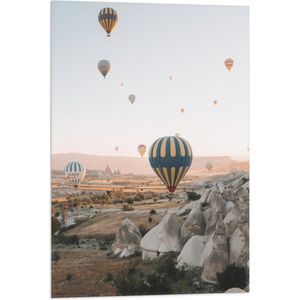 WallClassics - Vlag - Grote Groep Luchtballonnen Vliegend boven Rotsig Landschap - 50x75 cm Foto op Polyester Vlag