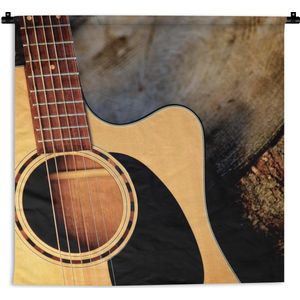 Wandkleed Akoestische gitaar - Een akoestische gitaar op een houten ondergrond Wandkleed katoen 60x60 cm - Wandtapijt met foto