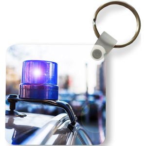 Sleutelhanger - Uitdeelcadeautjes - Zwaailicht van politieauto op een burgerauto - Plastic