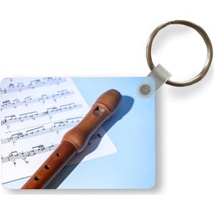 Sleutelhanger - Bruine blokfluit op bladmuziek - Uitdeelcadeautjes - Plastic