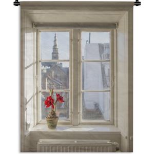Wandkleed Uitzicht - Uitzicht op de stad met een amaryllis in de vensterbank Wandkleed katoen 120x160 cm - Wandtapijt met foto XXL / Groot formaat!