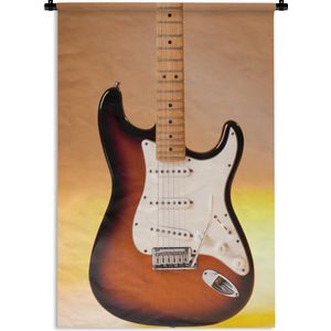 Wandkleed Elektrische gitaar - Een elektrische gitaar met een oranje achtergrond Wandkleed katoen 120x180 cm - Wandtapijt met foto XXL / Groot formaat!