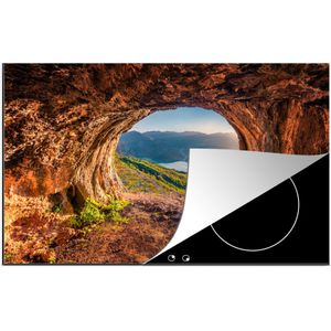 KitchenYeah® Inductie beschermer 85x52 cm - Grot - Berg - Landschap - Natuur - Kookplaataccessoires - Afdekplaat voor kookplaat - Inductiebeschermer - Inductiemat - Inductieplaat mat