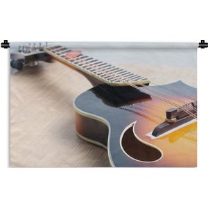 Wandkleed Elektrische gitaar - Een elektrische gitaar op een houten vloer Wandkleed katoen 90x60 cm - Wandtapijt met foto