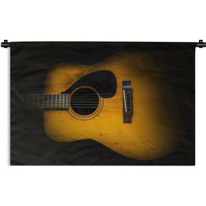 Wandkleed Akoestische gitaar - Oude akoestische gitaar op een donkere achtergrond Wandkleed katoen 60x40 cm - Wandtapijt met foto