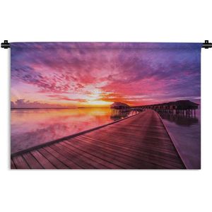 Wandkleed Zonsondergang op het Strand  - Kleurrijke zonsondergang boven een pier Wandkleed katoen 150x100 cm - Wandtapijt met foto