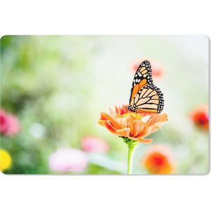 Bureau mat - Oranje vlinder in een bloemenveld - 60x40