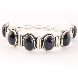 Zware bewerkte zilveren armband met blauwe zonnesteen