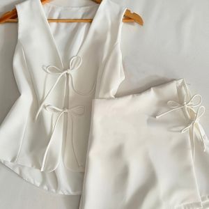 Elegante en casual reisoutfit met een vesttop met knopen en een stijlvolle korte broek-set.