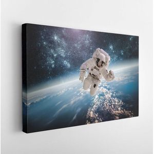 Astronaut in outer space against the backdrop of the planet earth. Elements of this image furnished by NASA- Modern Art Canvas - Horizontal - 241509286 - 40*30 Horizontal