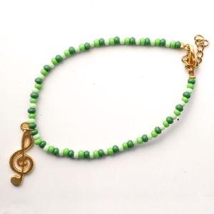 Armband groentinten met muzieksleutel - goud