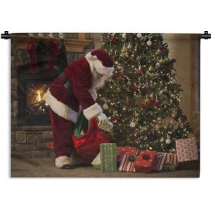Wandkleed Kerst - De kerstman zet cadeautjes onder de boom Wandkleed katoen 150x112 cm - Wandtapijt met foto