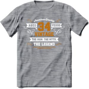 34 Jaar Legend T-Shirt | Goud - Wit | Grappig Verjaardag en Feest Cadeau Shirt | Dames - Heren - Unisex | Tshirt Kleding Kado | - Donker Grijs - Gemaleerd - XXL