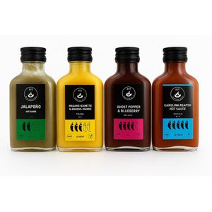 Hete Sauzen Pakket met 4 Hot Sauces - Carolina Reaper, Jalapeño, Madame Jeanette, Ghost Pepper - Handgemaakt in Nederland - Vegan, Glutenvrij, Keto friendly - Natuurlijk van de lokale boer - Kerst kado, Sinterklaas kado - Saus Met Pit - 4x 100ml