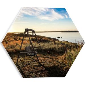 WallClassics - PVC Schuimplaat Hexagon  - Schommelbank in het Veld aan het Water - 30x26.1 cm Foto op Hexagon (Met Ophangsysteem)