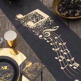 Santex muziek thema tafelloper op rol - 5 m x 30 cm - zwart/goud - non woven polyester